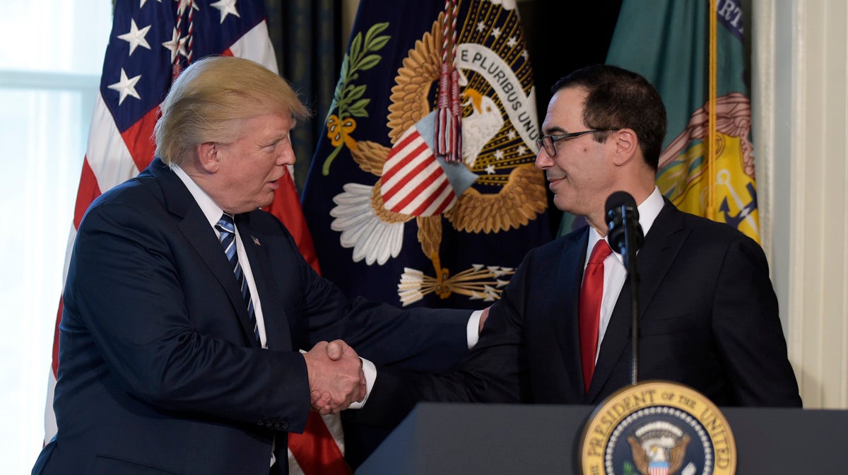  President Donald Trump shakes hands with Treasury Secretary Steven Mnuchin at the Treasury Department in Washington, Friday, April 21, 2017, where the president signed an executive order to review tax regulations set last year by his predecessor. (AP Photo/Susan Walsh) 