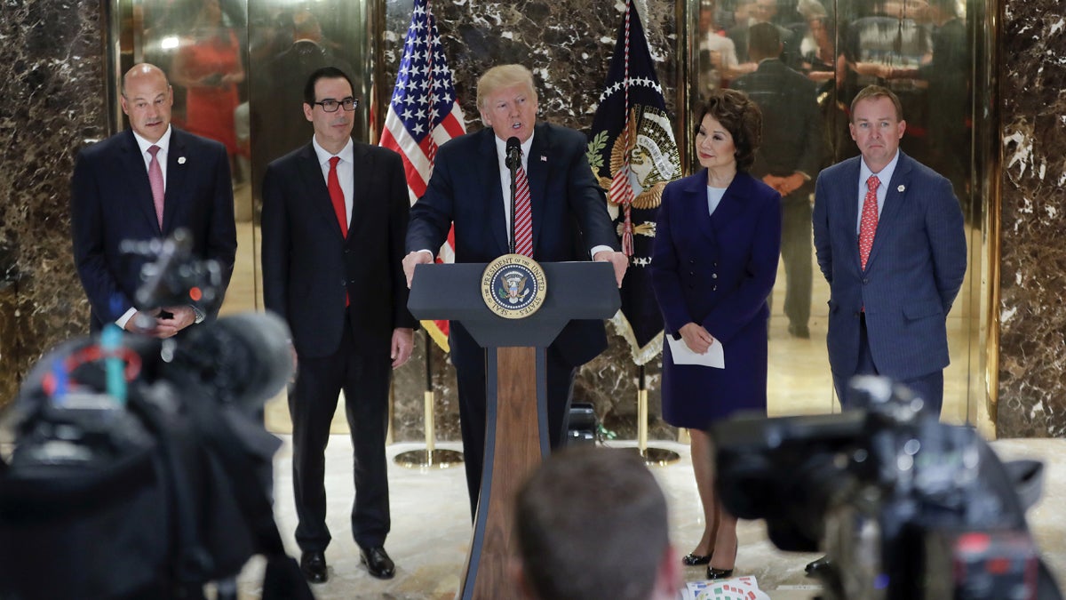  President Donald Trump speaks to the media in the lobby of Trump Tower, Tuesday, Aug. 15, 2017 in New York. With Trump are from left, National Economic Council Director Gary Cohn Treasury Secretary Steven Mnuchin, Transportation Secretary Elaine Chao and OMB Director Mick Mulvaney. (AP Photo/Pablo Martinez Monsivais) 