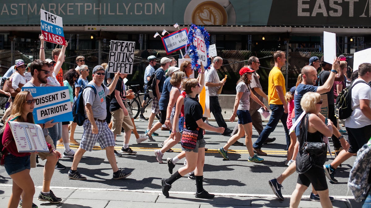 Demonstrators marched down Market Street Sunday morning calling for the impeachment of President Donald Trump. (Brad Larrison for NewsWorks)