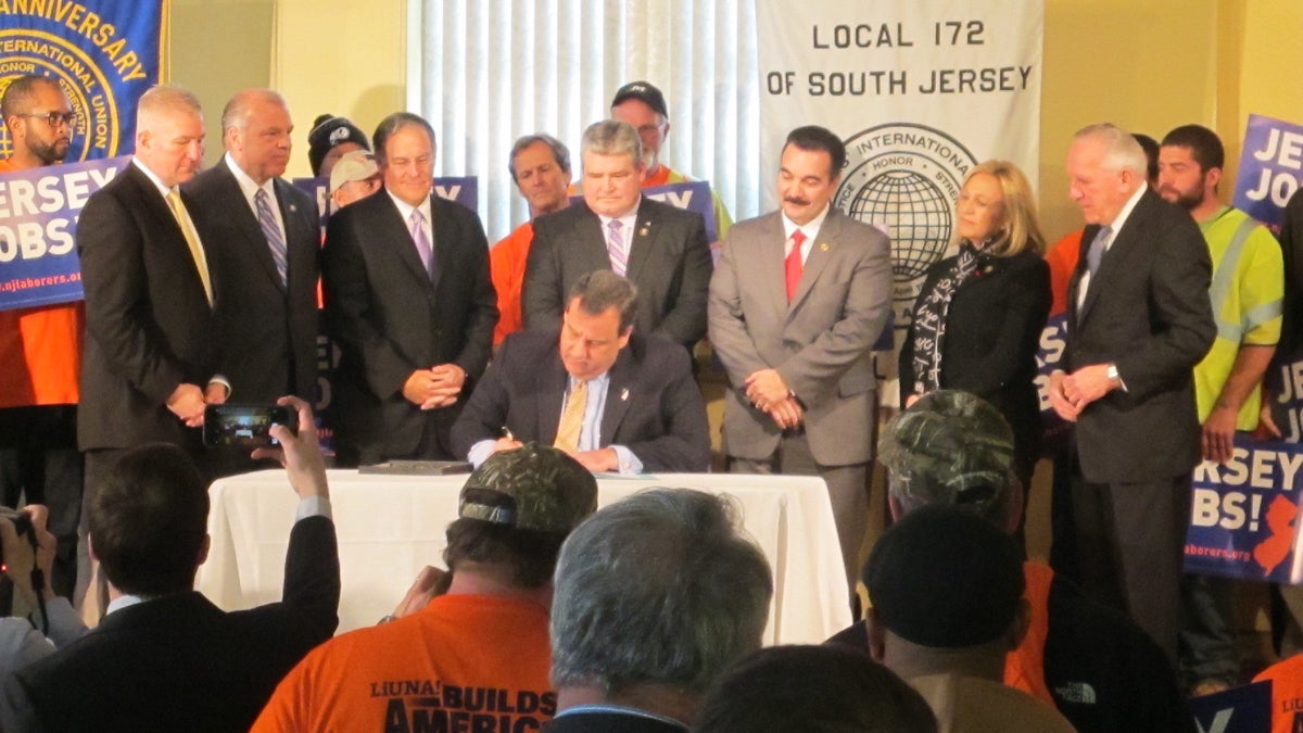  Gov. Chris Christie signs the legislation at International Laborers Union hall in Trenton. (Phil Gregory/WHYY) 