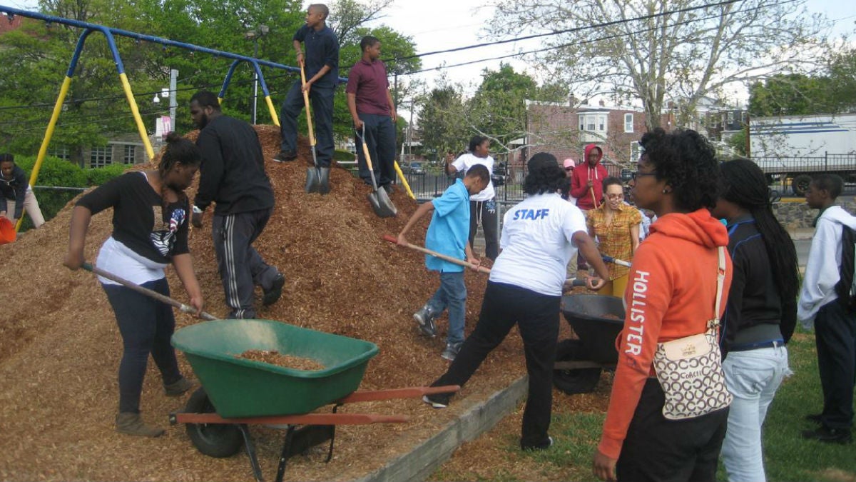  Workers add mulch underneath playground  equipment at Father Tucker Park in Wilmington's Little Italy section. (photo via WestSideGrows.org) 
