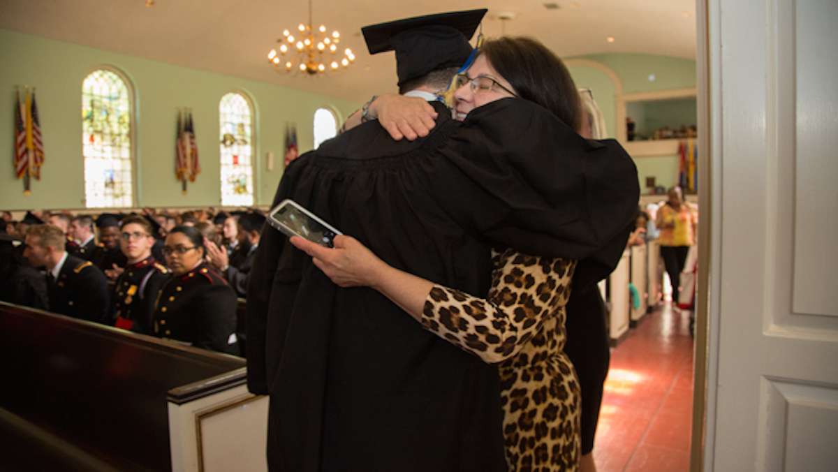 Clarence Morris hugs a family member after receiving his diploma from the Valley Forge Military College, May 20, 2016.