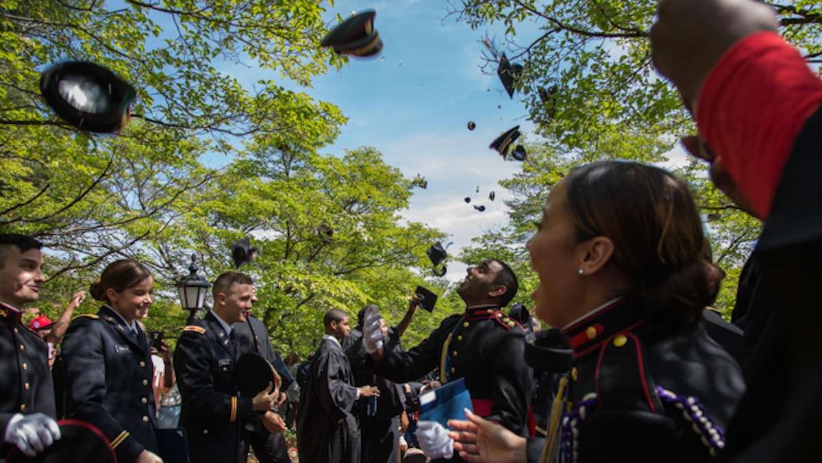 Graduates from the 2016 class of Valley Forge Military College line the pathway outside of the Alumni Memorial Chapel and ceremoniously throw their hats in the air to offically mark their graduaton, May 20, 2016.