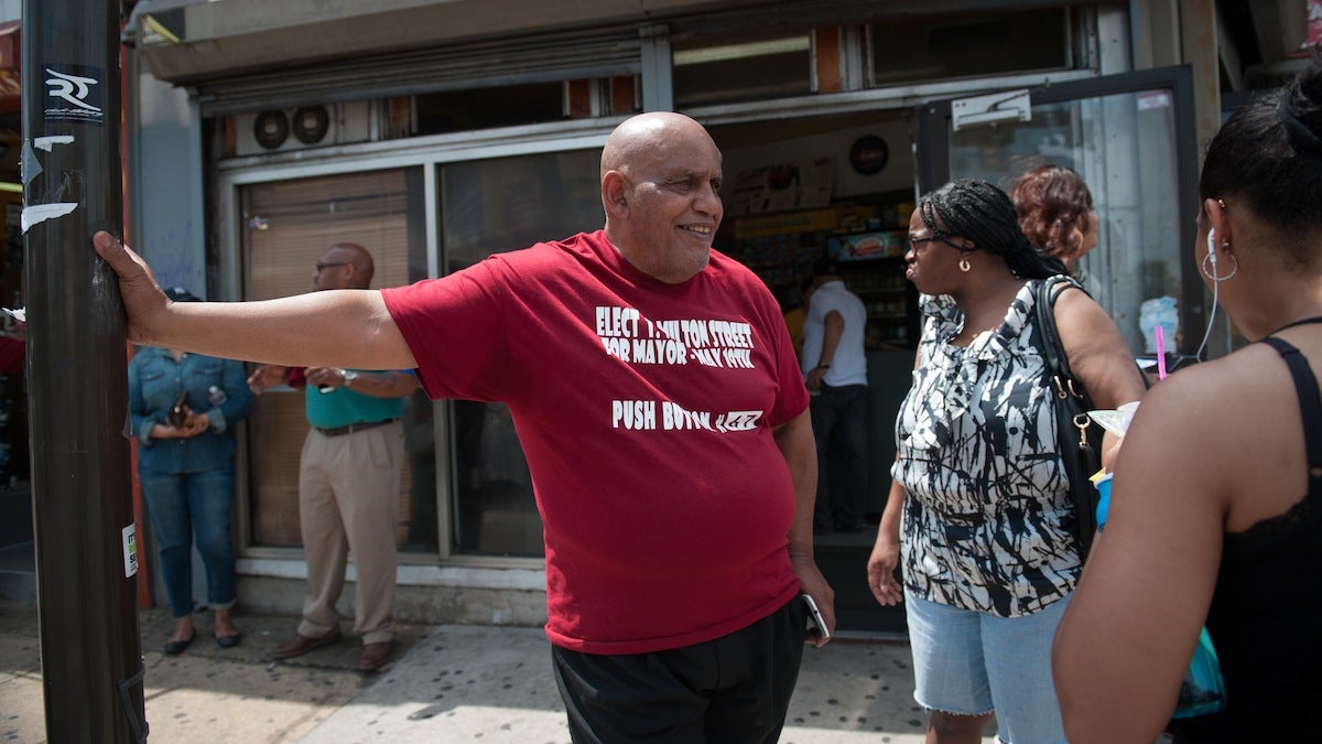 Mayoral candidate T. Milton Street talks with people at the corner of Broad and Erie Tuesday morning.