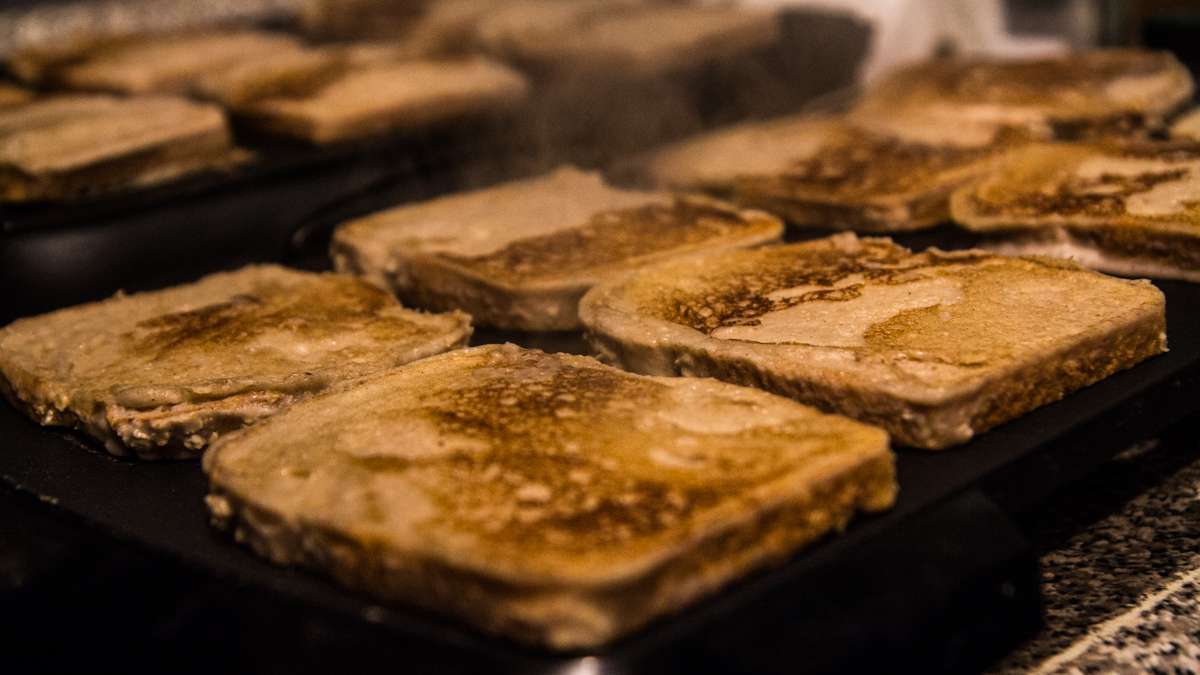 Vegan French toast slices cook on the griddle in the kitchen of Lava Space.