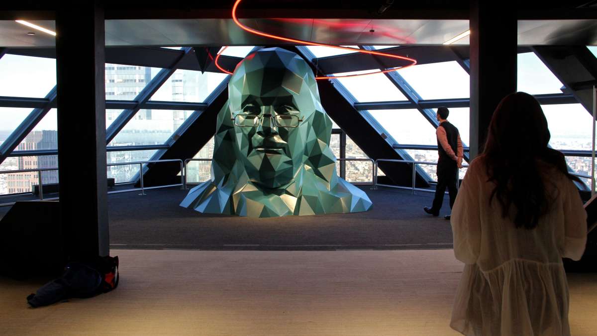 On the 57th floor, Ben Franklin's head emerges.