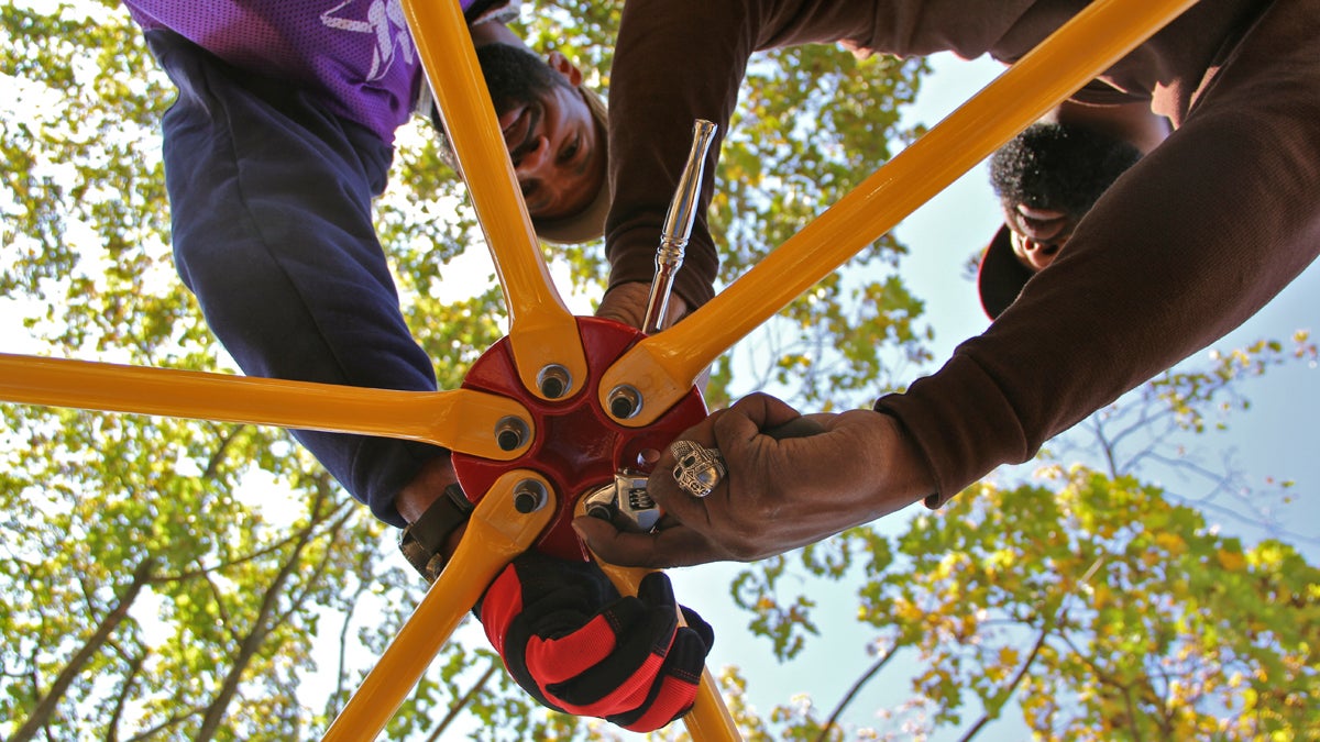  Volunteers Steve Chambers and Joseph Young help to assemble playground equipment at West Philadelphia Achievement Charter School. (Emma Lee/for NewsWorks) 