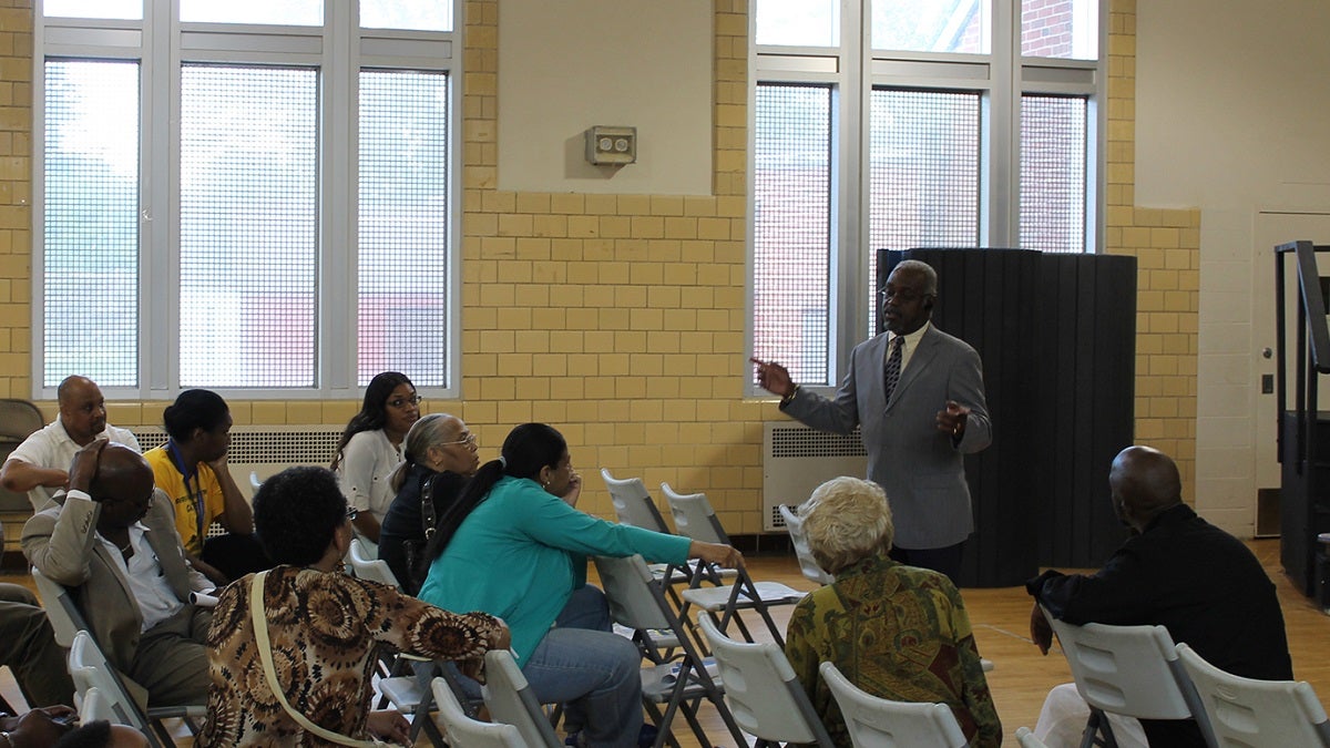  Anthony Murphy, executive director of the city's Town Watch Integrated Services, speaks with East Germantown residents in the wake of an alleged serial rapist's arrest. (Matthew Grady/for NewsWorks) 