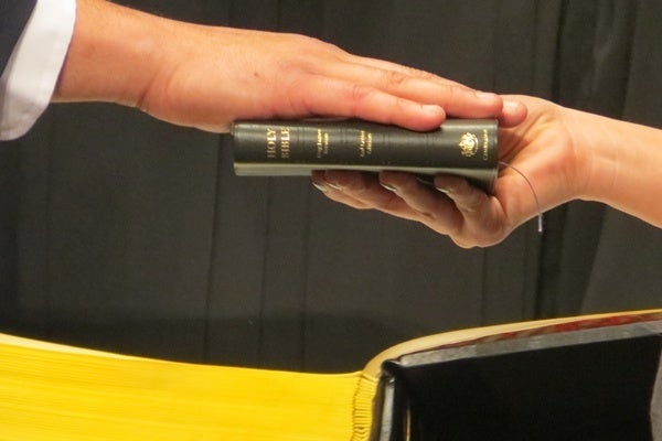 <p><p>Fire chief Anthony Goode's right hand on the bible as he takes his oath of office (Shirley Min/WHYY)</p></p>
