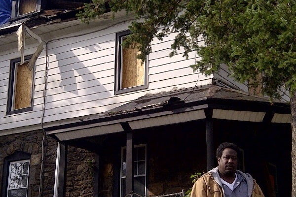 <p><p>Ben Folk stood outside his family's East Oak Lane home days after it was gutted when Hurricane Sandy's outer bands sparked a blaze on Independence Street. (Brian Hickey/WHYY)</p></p>
