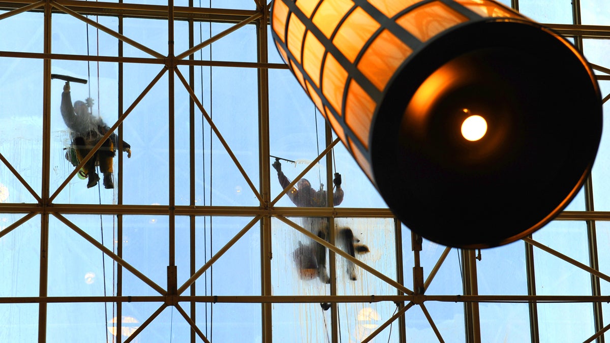  Window washers clean the glass covering the entrance and lobby at the Sheraton Philadelphia Downtown Hotel on N. 17th Street. (Photography by Peter Tobia) 