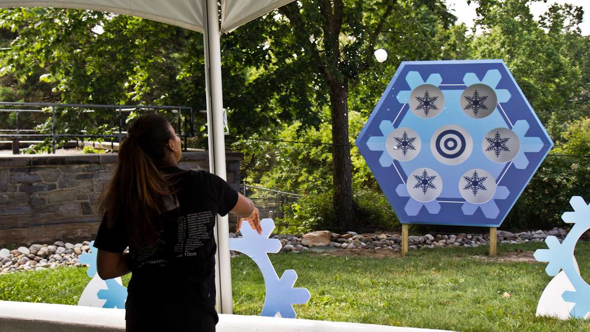 Talia Cooper throws a snowball at the target at the Winter exhibit.