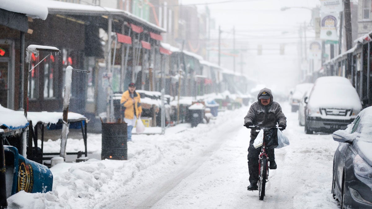  A man rides his bicycle during a winter storm in the Italian Market neighborhood of Philadelphia, Tuesday, March 14, 2017. (AP Photo/Matt Rourke) 