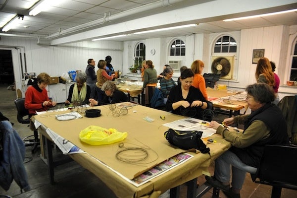<p><p>Artists and volunteers pack the room at Cheltenham center for the Arts, where they make wire vessels which will be featured in a year-long installation called One Year. (Anna Flint/for NewsWorks)</p></p>
