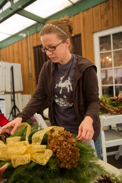 <p><p>Sara Beth Kane of Mt. Airy decorates a wreath at the Winter in the Wissahickon event hosted by the Friends of the Wissahickon. (Dave Tavani/for NewsWorks)</p></p>
