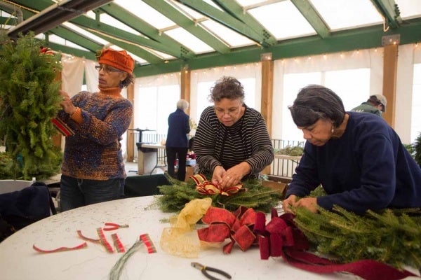 <p><p>Dorothy Page, of Abington, Connie Sandlin, of North Philadelphia, and Bobby Morris, of Germantown decorate wreaths at the Winter in the Wissahickon event. (Dave Tavani/for NewsWorks)</p></p>
