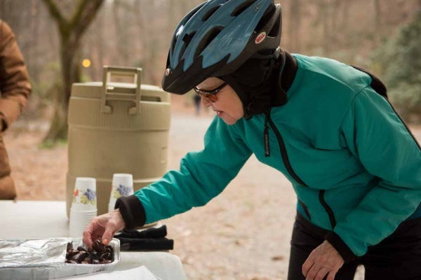<p><p>Alice Clark of Center City tries out some fire-roasted chestnuts at the Winter in the Wissahickon event hosted by the Friends of the Wissahickon. (Dave Tavani/for NewsWorks)</p></p>
