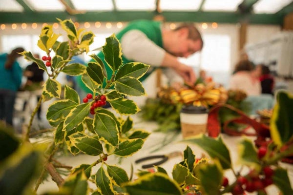 <p><p>Aaron Erpel of Mt. Airy decorates a wreath at the Winter in the Wissahickon event. (Dave Tavani/for NewsWorks)</p></p>
