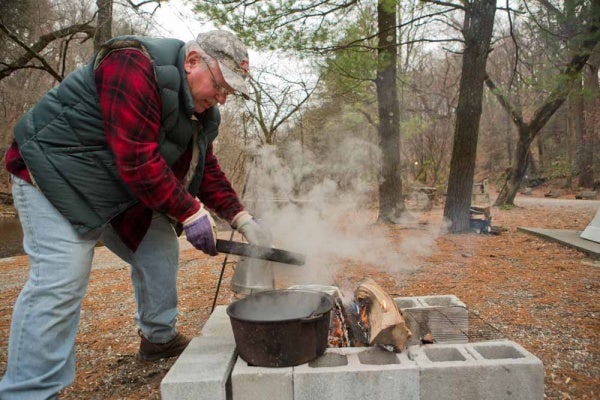 <p><p>Fairmount Park maintainence worker and FOW volunteer Steve Okula checks on the roasting chestnuts at the Winter in the Wissahickon event. (Dave Tavani/for NewsWorks)</p></p>
