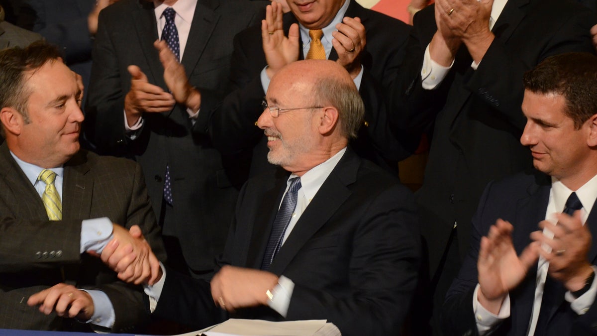  Democratic Gov. Tom Wolf shakes hands with Senate Majority Leader Jake Corman, R-Centre, after signing legislation designed to reduce long-term public pension costs during a ceremony in the Pennsylvania Capitol on Monday, June 12, 2017 in Harrisburg, Pa. Looking on at right is House Majority Leader Dave Reed, R-Indiana. (AP Photo/Marc Levy) 