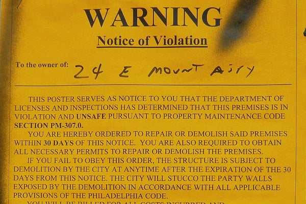 <p><p>Notice of violation posted on the building (Alan Tu/WHYY)</p></p>
