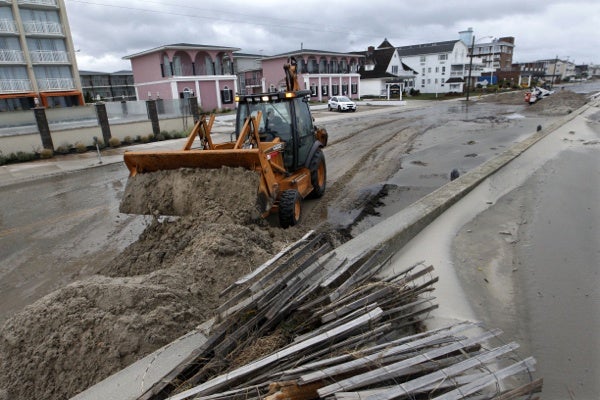 <p>Workers use heavy machinery to clean up damage from superstorm Sandy Tuesday morning, Oct. 29, 2012, in Cape May, N.J., after a storm surge from Sandy pushed the Atlantic Ocean over the beach and across Beach Avenue.  (AP Photo/Mel Evans)</p>
