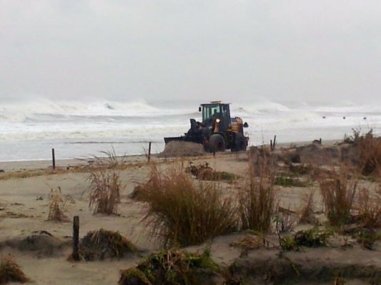 <p><p>Crews in Ocean City are rushing to build up the dunes before high tide. (Tom Mac Donald/WHYY)</p></p>
