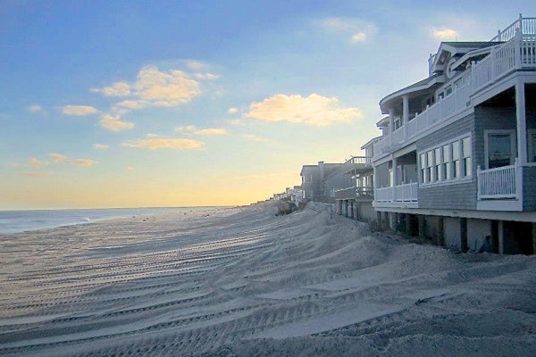 <p><p>Crews push sand up against the homes in Beach Haven, N.J. on Monday. (Photo courtesy of Denis Devine)</p></p>
