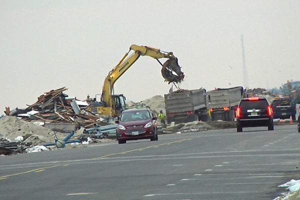 <p><p>Ocean Ave. in Belmar is supposed to be closed to traffic. Clean up crews removing parts of the broken up boardwalk. (Alan Tu/WHYY)</p></p>
