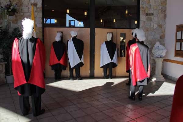 <p>With no seats available inside St. Agnes Church in Blackwood, members of the Knights of Columbus watch from the vestibule as Dennis J. O'Connor is installed as 8th Bishop of Camden. (Emma Lee/for NewsWorks)</p>
