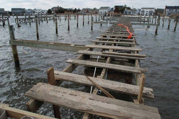 <p>Workers must step gingerly as they restore plumbing and electricity to damaged piers. (Sandy Levine/for NewsWorks)</p>
