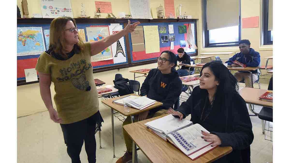 Paula Saillard teaches French class at Woodrow Wilson High School to Minh Le, 16, center; and Janneiry Martinez, 17.