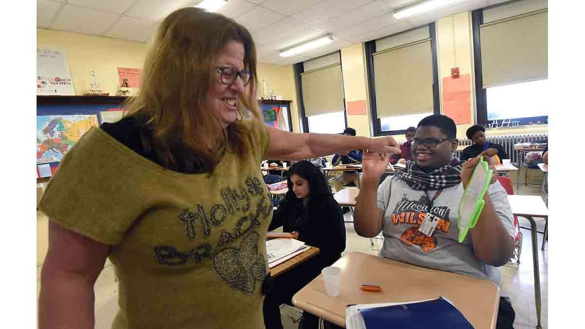 rench teacher Paula Saillard fist-bumps French student Dyrell Mack, 18, in class.