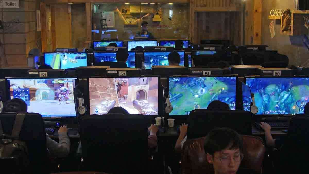 In this Aug. 30, 2016 photo, people play computer games at a PC cafe in Seoul, South Korea. South Korea has the biggest e-sports industry in the world with professional leagues and broadcasting channels.