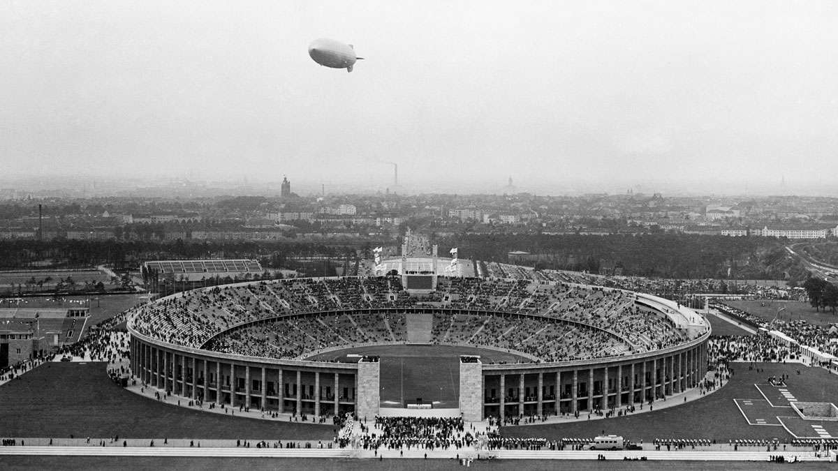 The German airship Hindenburg flies over the Olympic Stadium, outside Berlin, on August 1, 1936, during the opening ceremony of the Olympic Games.