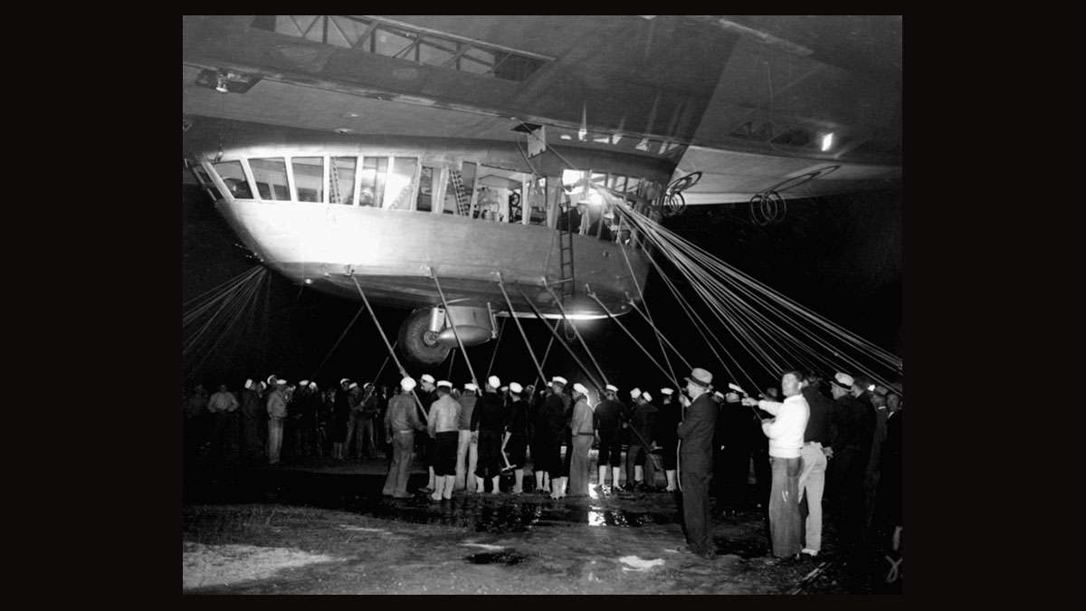 Spectators and ground crew surround the gondola of the German zeppelin Hindenburg as the lighter-than-air ship prepared to depart the U.S. Naval Station at Lakehurst, NJ, May 11, 1935, on its return trip to Germany.