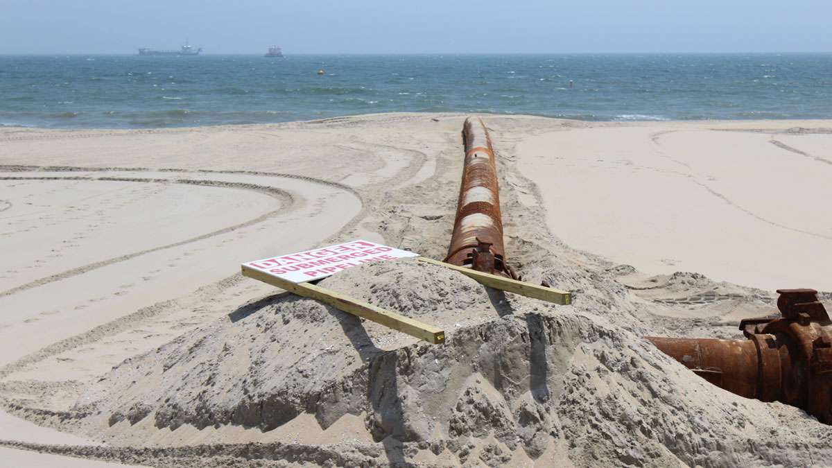 Pipes are used to pump water and sand from the ocean floor onto the beach.