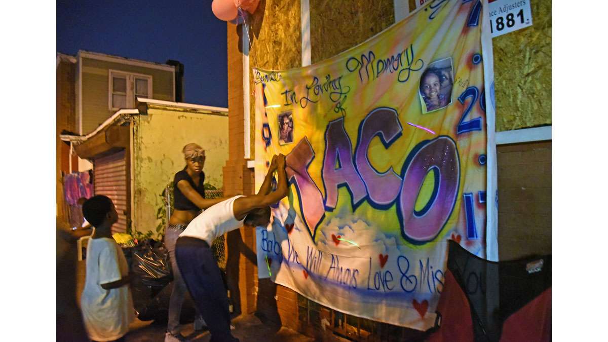 Brandon Simms breaks down at the memorial to his daughter Laiyannie Williams, killed in a rowhome fire on Morton Street on July 28. Next to him is Laiyannie's aunt, Jamillah Williams.