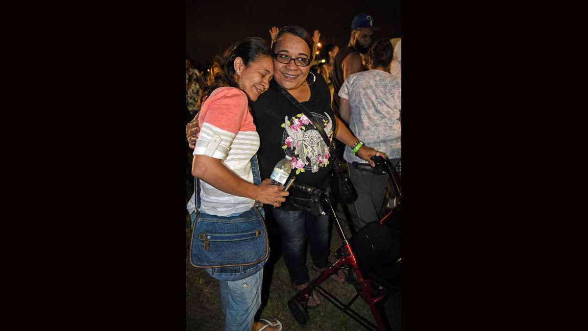 On August 21 at Von Nieda Park, Angela Martinez, right, says the pain in her spine disappeared after Jonathan Shuttlesworth layed hands on her.