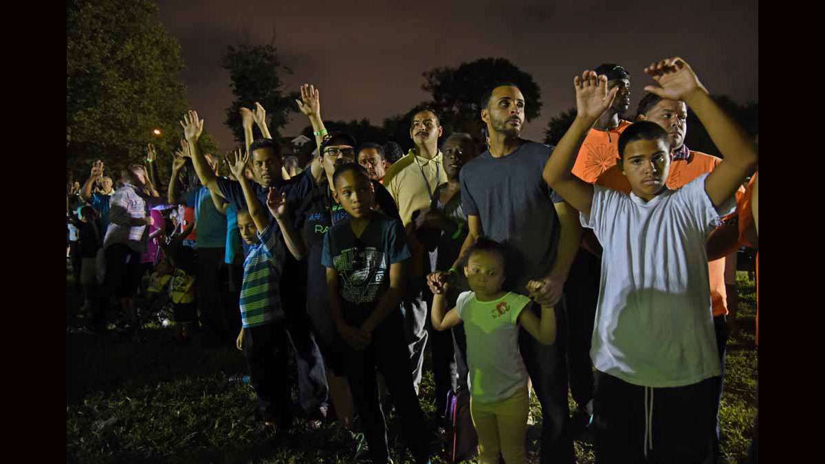 On August 21 at Von Nieda Park, Festival of Life attendees wait for Jonathan Shuttlesworth to lay hands on them.