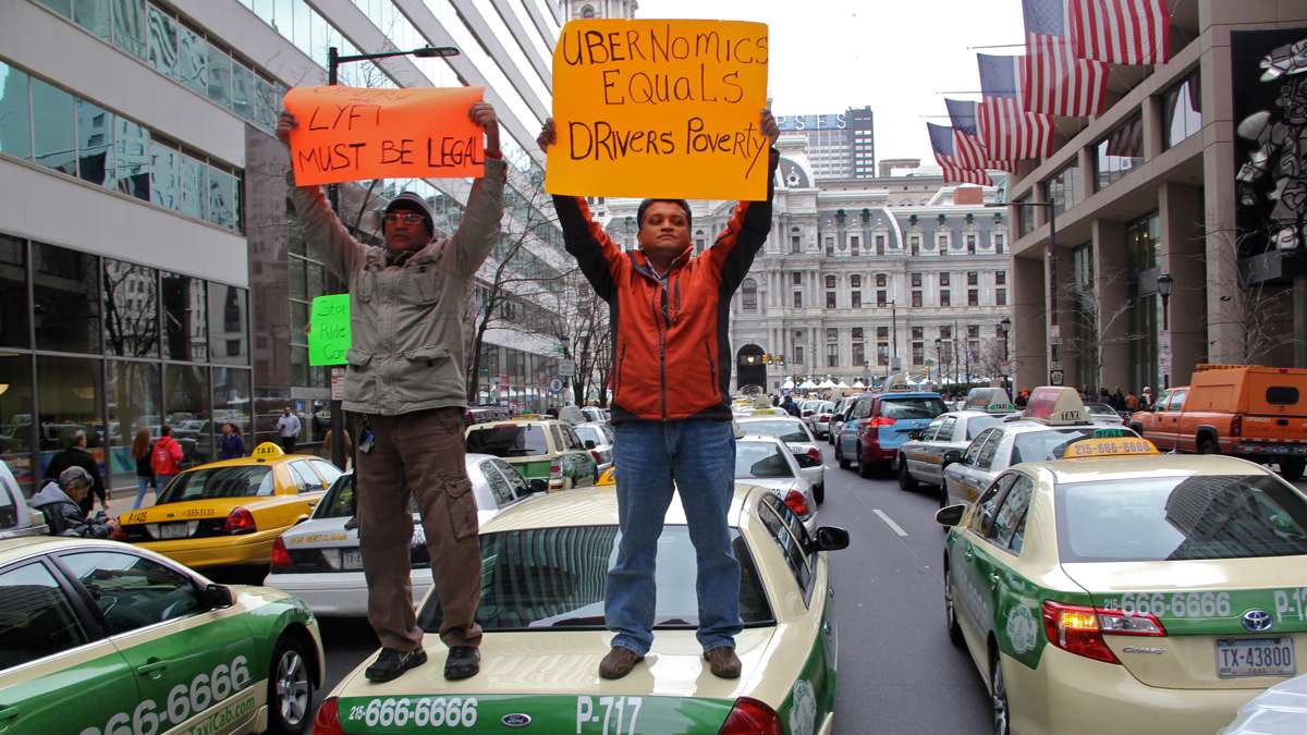 Hundreds of taxi and limosine drivers stop traffic around City Hall protesting unfair competition from rideshare organizations like Lyft and Uber. (Emma Lee/WHYY)