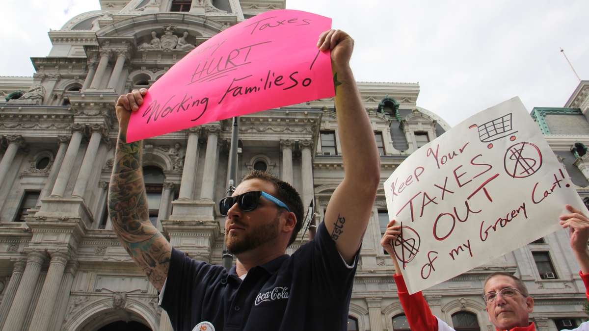 Protesters demonstrate outside City Hall while Council considers a sugary drink tax that will fund universal preschool and recreation centers. The measure will take effect Jan. 1, 2017, although the city still faces legal challenges. (Emma Lee/WHYY) 