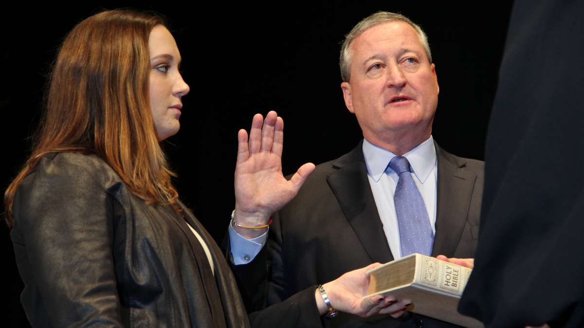 Jim Kenney is sworn in as Philadelphia's 99th mayor at the Academy of Music while his daughter, Nora, holds the Bible. (Emma Lee/WHYY)