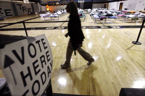<p><p>A person walks through a makeshift shelter in a gymnasium at Toms River East High School as they arrive to vote Tuesday, Nov. 6, 2012, in Toms River, N.J. (AP Photo/Mel Evans)</p></p>
