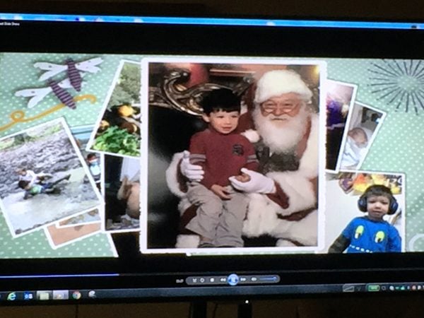 Photos on a computer screen of slain Brendan Creato, sitting on Santa's lap, etc.