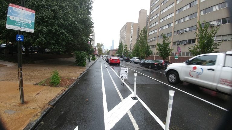  New 'buffered' bike lanes unveiled on Chestnut Street in West Philadelphia.  Bike lane is to the left, on-street parking is next and after that are regular travel lanes (Tom MacDonald/WHYY). 
