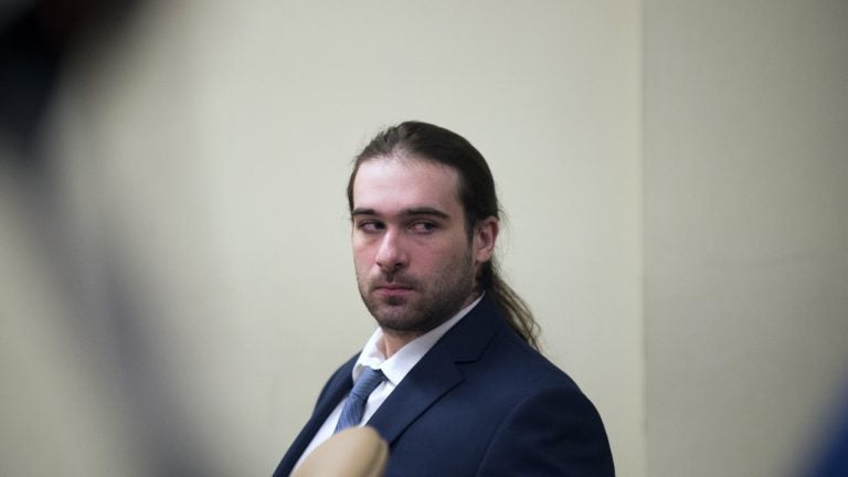 Man with ponytail in blue suit