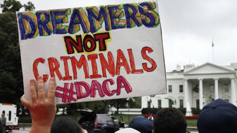  FILE- In this Aug. 15, 2017, file photo, a woman holds up a signs in support of the Obama administration program known as Deferred Action for Childhood Arrivals, or DACA, during an immigration reform rally at the White House in Washington. (AP Photo/Jacquelyn Martin, File) 