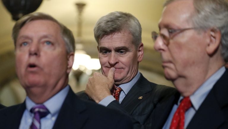 Sen. Bill Cassidy, R-La., center, listens as Sen. Lindsey Graham, R-S.C., left, speaks, accompanied by Senate Majority Leader Mitch McConnell of Ky., on Capitol Hill, Tuesday, Sept. 19, 2017 in Washington. (AP Photo/Alex Brandon)