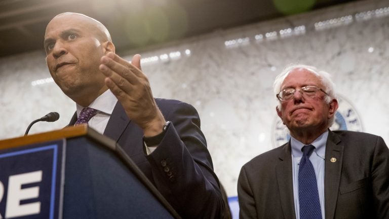  Sen. Cory Booker, D-N.J., (left), accompanied by Sen. Bernie Sanders, I-Vt., (right), speaks during a news conference on Capitol Hill in Washington, Wednesday, Sept. 13, 2017, to unveil their Medicare for All legislation to reform health care. (Andrew Harnik/AP Photo) 